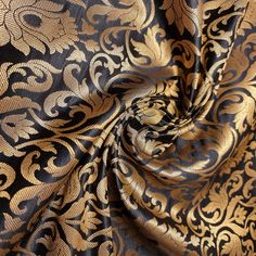 a black and gold fabric with an intricate design