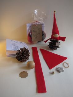 an elf's hat, pine cone and other items on a table