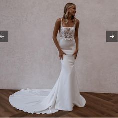 a woman in a white wedding dress standing on a wooden floor next to a wall