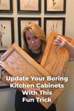 a woman holding up some framed pictures with the words update your boring kitchen cabinets with this fun trick