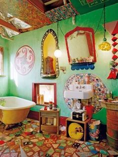 a bathroom decorated in bright colors with an old fashioned bathtub and antique mirror on the wall