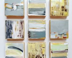 nine abstract paintings are arranged in rows on the wall