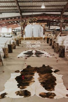 the aisle is decorated with cow hide rugs