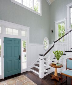 an entryway with blue doors and white railings is shown in this house's interior