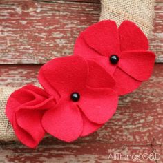 two red flowers are attached to a burlock