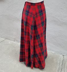 Warm and cozy 1970s wool Maxi skirt. This A-line  skirt  has a beautiful red , green , and navy plaid design. Create a great fall look with boots and a sweater , or dress it up for the Holidays. Excellent condition. waist - 28 inch hips- 40 inch waist to hem - 41 inch Red Full Skirt Bottoms For Fall, Classic Plaid Skirt For Fall, Vintage A-line Skirt For Fall, Retro Full Skirt Bottoms For Winter, Vintage Flared Skirt For Fall, Scottish Red Skirt For Fall, Vintage Flared Skirt Bottoms For Fall, Red Pleated Skirt For Fall, Retro Red Skirt For Fall