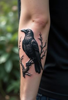 a black bird sitting on top of a tree branch with leaves and branches around it