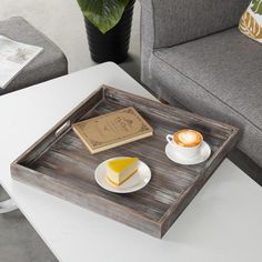 a tray with some food on top of it next to a cup and saucer