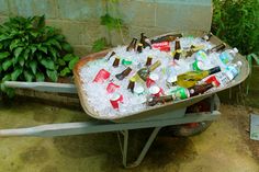 a wheelbarrow filled with bottles and ice