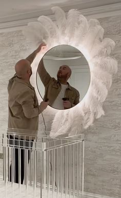 a man standing in front of a mirror