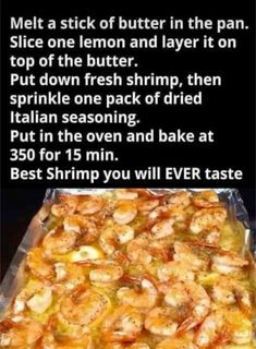 a large pan filled with shrimp on top of a table next to a sign that says,