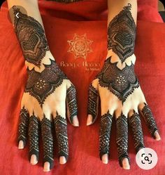 two hands with henna tattoos on them