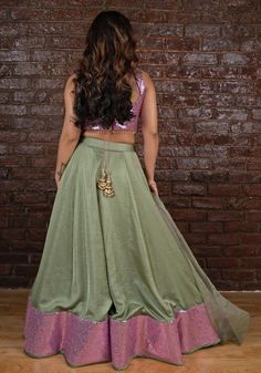 Elevate your style with the exquisite sage green and lavender Lehenga set. Crafted from luxurious silk, the set features a glam lavender sequinned blouse adorned with delicate tassel detailing. Beautifully complemented by a raw silk skirt and a shaded organza dupatta. Embrace elegance and grace with the sage green and Lavender Lehenga set. Perfect for Mehndi, Sangeet, or as a wedding guest. Composition : Raw Silk, georgette Care: Dry Clean Only and Vacuum Storage This product can be customized for sleeves, length and colour Delivery : 4-6 weeks as the product is hand crafted. Check Size Guide or choose MySize for free customisation (All Sizes above XL can be made at 15% additional cost) For more information and sizes please contact fabiliciousfashion@gmail.com or visit our Copenhagen studi Green Raw Silk Sets For Party, Lavender Anarkali Set For Party, Festive Lavender Sets With Mirror Work, Lavender Saree Set For Party, Lavender Saree For Party, Elegant Pista Green Sequined Set, Lavender Party Set With Sheer Dupatta, Semi-stitched Lavender Sets For Party, Party Sets With Lavender Color And Dupatta