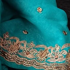 Georgette Sari Is Such A Rich Tone Of Teal With Gorgeous Rich Copper Embroidery And Beading. Rare Combination Of Colors, It's Truly Gorgeous. Please Note The Color Is Just Slightly Darker Than In Pictures And Copper Is Darker Than Appears In Picture, It's A Very Rich High-End Look. The Embroidery And Beading Is Very Finely Done, This Is Not A Cheap, Quickly Finished Garment, Attention To Workmanship And Detail Is Evident. Finely Done Copper Buttis All Over The Visible Area, And Almost 2-Inch Edging Adds Sophistication And Glamor To This Beautiful Subtle Tone On Tone Print Background. This Saree Comes With Matching Lined Blouse In Size L(38-39 Inch Bust) But Can Be Let Out 2-2.5 Inches. Roun Elegant Turquoise Dupatta For Festive Occasions, Elegant Turquoise Dupatta With Zari Work, Traditional Turquoise Dupatta With Intricate Embroidery, Traditional Blue Embellished Dupatta, Teal Saree, Party Turquoise Dupatta With Resham Embroidery, Blue Embroidered Saree Fabric With Intricate Details, Elegant Blue Embroidered Saree Fabric, Bohemian Blue Embroidered Wedding Fabric