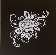 a black and white drawing of a rose with swirls on it's side