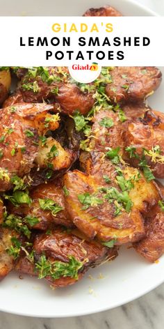 a white plate topped with fried potatoes covered in herbs