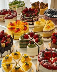 a table topped with lots of different types of cakes