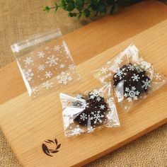 two pieces of chocolate cake sitting on top of a wooden cutting board next to each other