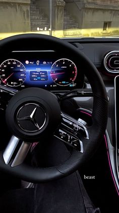 the steering wheel and dashboard of a mercedes c - class coupe with an electronic display