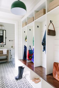 the inside of a white room with wooden shelves and shoes on it's shelf