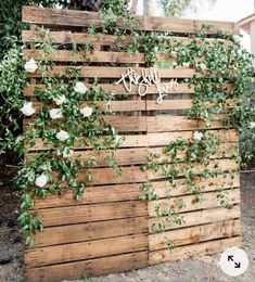 a wooden fence with flowers and greenery on it that says,'happy birthday '