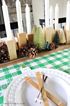 the table is decorated with pine cones and candles