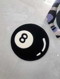 a black and white rug with a smiley face on it next to a pair of socks