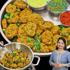 a woman standing in front of a platter of food and bowls of dips