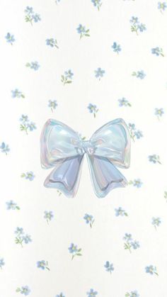 a white wall with blue flowers on it and a large bow hanging from the side