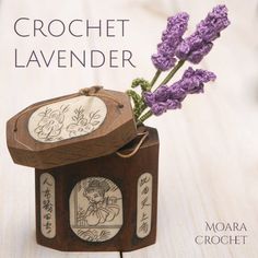 a small wooden box with flowers in it on a table next to the words crochet lavender