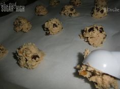 chocolate chip cookies and an egg are on a baking sheet, ready to be eaten