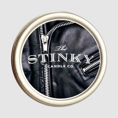 the stinky candle co logo on a black leather jacket with zippers and white trim