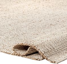 a close up view of an area rug with the corner cut out to show it's natural texture