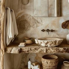 a bathroom with stone counter tops and a sink in the middle, surrounded by baskets