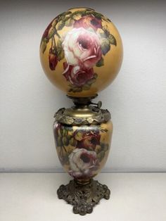 an ornate vase with flowers painted on it