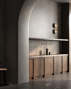 a kitchen with wooden cabinets and counter tops in an arch - shaped space between two walls