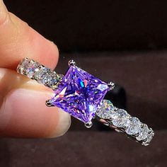 Stunning Purple Zircon Square-Cut Stone With Round Accent Stones Set In Silver Plating. Sparkling Purple Jewelry For Gift, Sparkling Purple Jewelry Gift, Ice Ring, Ring Color, Square Cut, Stone Settings, Womens Jewelry Rings, Color Purple, Lavender