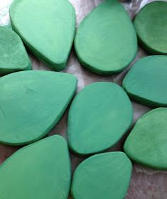 several green pieces of wood sitting on top of a table