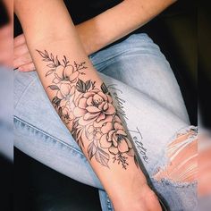 a woman's arm with flowers on it