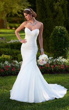 a woman in a wedding dress posing for the camera