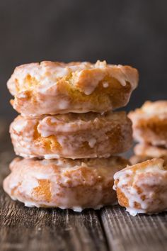 a stack of doughnuts sitting on top of a wooden table