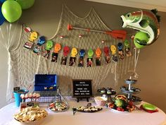 a table topped with lots of food and balloons