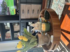 a vase filled with flowers sitting on top of a wooden shelf