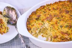 a casserole dish with broccoli and cheese in it next to a spoon