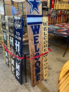 two wooden signs with the words welcome to our neighborhood and a blue star on them