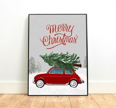 a red car with a christmas tree on the roof is parked in front of a white wall