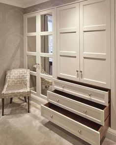 an empty room with white cabinets and drawers