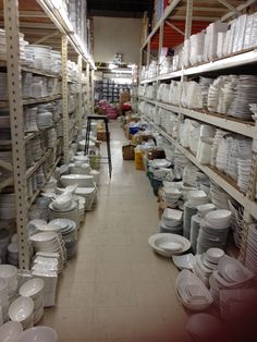 rows of shelves filled with white plates and bowls