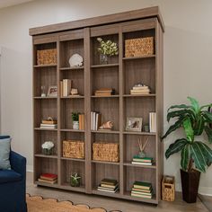 a living room with a blue couch and bookcase