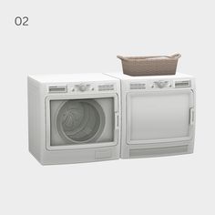 a white washer and dryer sitting next to each other in front of a basket